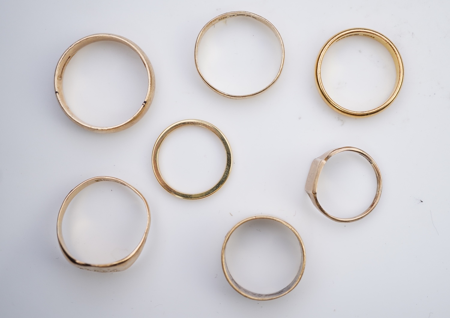 A collection of seven gold rings